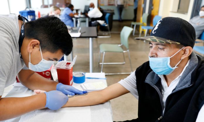 registered nurse with The Los Angeles Department of Public Health administers a Mpox vaccine